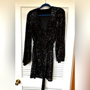Cute black sequined midi dress. Measures 24” from armpit to hem. Never worn.